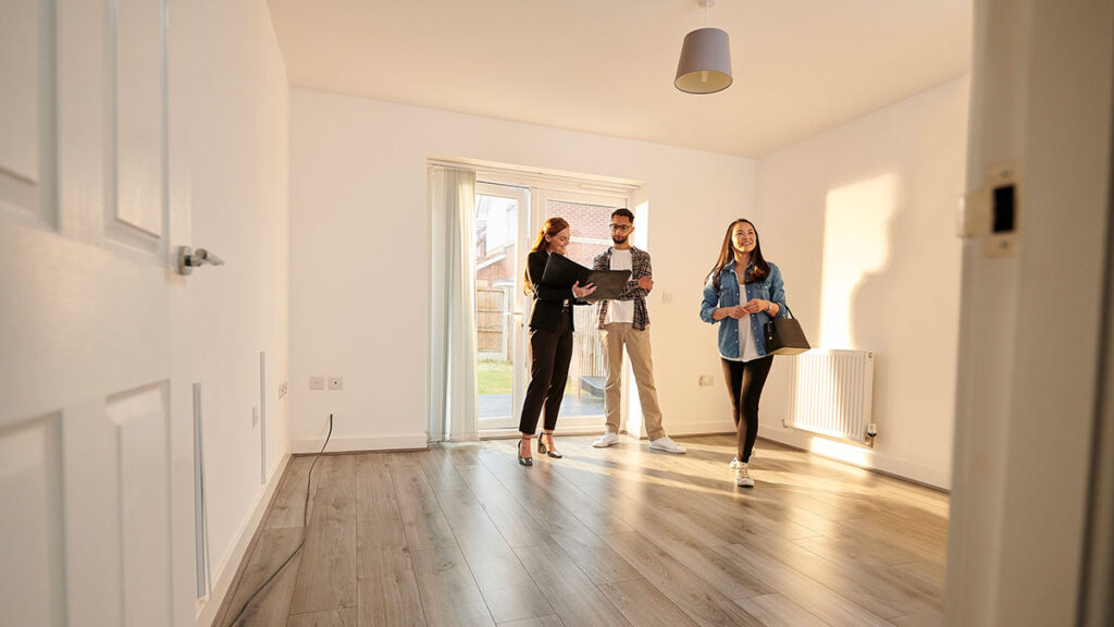 Estate agent showing couple round empty house