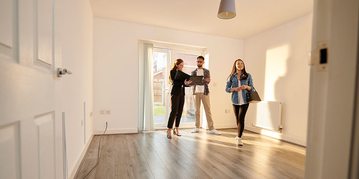 Estate agent showing couple round empty house